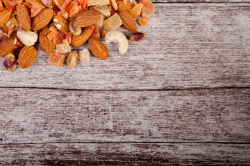 Healthy different type of nuts and sweet on wooden background in studio photo