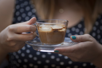 Hands holding coffee cup