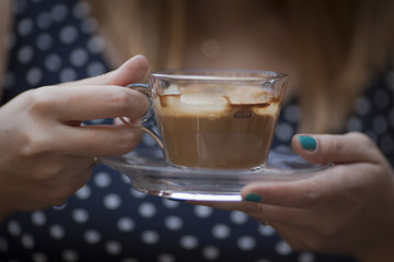 Hands holding coffee cup
