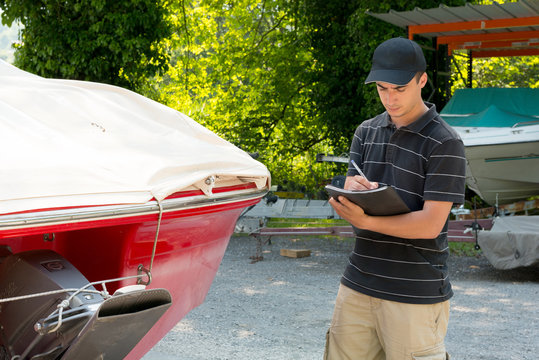 Young Mechanic Checking The Motor Boat