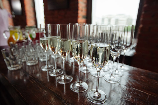 Many glasses of champagne over blur glasses background