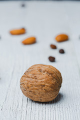 Walnut lie on an old wooden white table,  with cracked paint