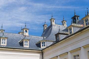Fototapeta na wymiar Roof of Pillnitz Castle, Dresden, with windows and many small chimneys, crenelations