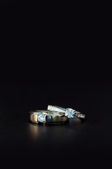 wedding ring on black table with soft-focud and over light in the background