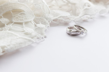 wedding ring on white table with soft-focus and over light in the background