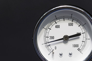 The industrial gauge (gage) on the black background.The industrial measurement instrument.