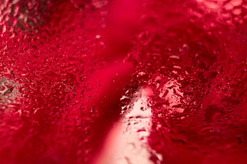 Abstract red background, condensation on glass, water drops