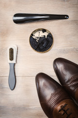 Top view fashionable men's shoes and accessories shoe care on wooden background