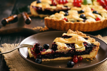Homemade blueberry pie on wooden background.