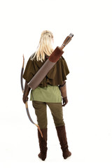 full length portrait of a blonde girl wearing green and brown medieval costume, holding a bow and...