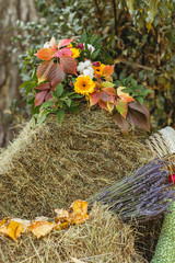 autumn foliage with decotative orange flowers on haystack