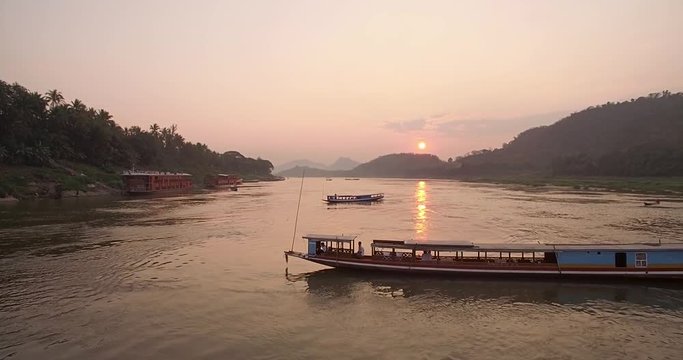 Tourist Cruise Boats on The Mekong River at Sunset, Luang Prabang, Laos, Aerial Shot
