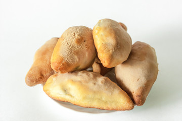 Pies on a white plate on a white background
