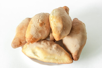 Pies on a white plate on a white background