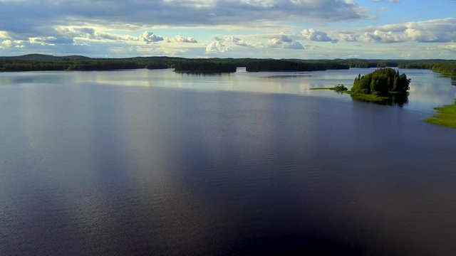 Aerial shot of beautiful lake on a windy cloudy day. 4K video.
