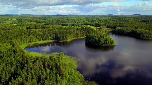 Aerial shot of beautiful islands at lake on a calm summer evening. 4K video.