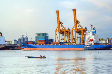Shipping port, Container Cargo freight ship with working crane loading bridge in shipyard at dusk for Logistic Import Export in Bangkok (With blur trademark, brand, logo.) 