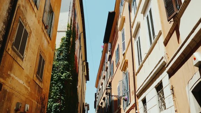 A cozy narrow street in the old historical part of Rome. Steadicam wide lens shot