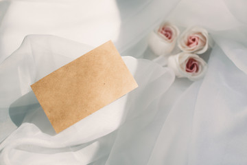 Mockup. Card on white romantic background with flowers. top view