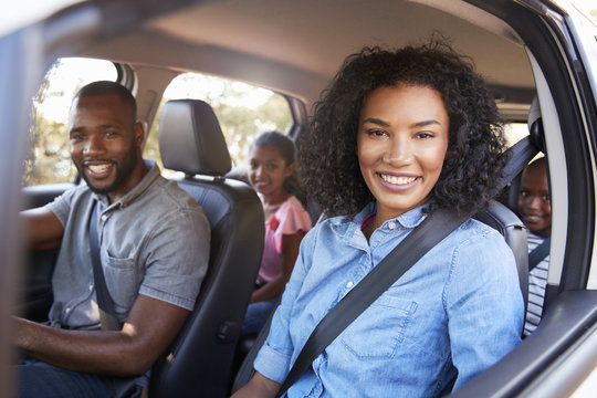Young Black Family In A Car On A Road Trip Smiling To Camera