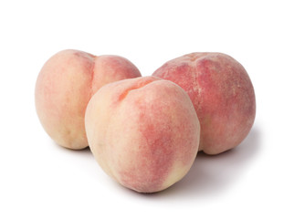 Three peaches on the white bckground.
 