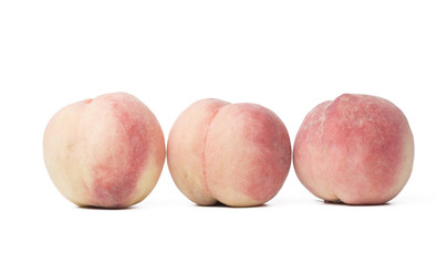 Three peaches on the white background.
 