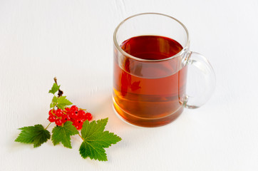 Cup of black tea with red currants