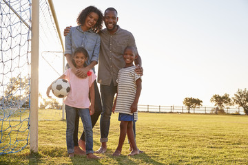 Portrait of a young black family during a football game © Monkey Business