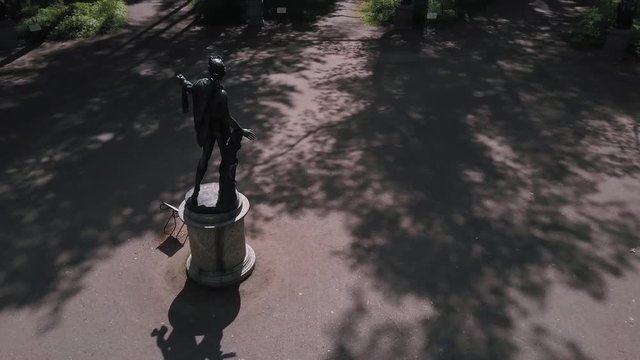 Bronze statues standing in the forest in the thicket among the trees of different gods male female statues of the Venus Zeus Cupid