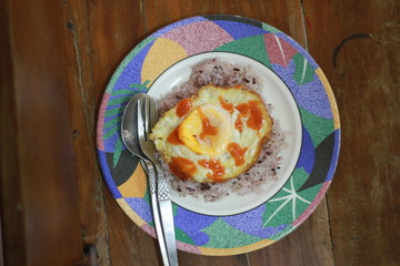 The eggs are on the rice.