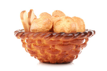 Braided bread basket with delicious buns on white background