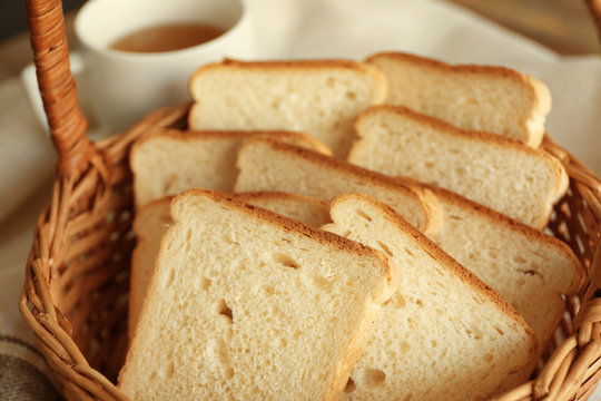Wicker basket with delicious sliced bread, closeup