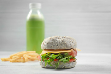 Delicious sandwich with fish on wooden table