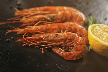 Delicious royal shrimps and lemon on table