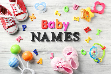 Composition with text BABY NAMES on wooden background