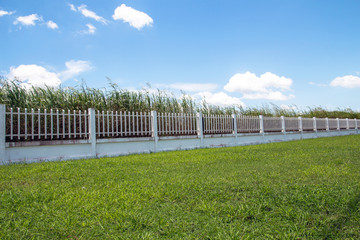 beautiful of fence factory in industrial estate,green field and stone with blue sky and cloud as background