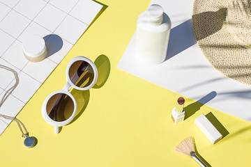 Summer yellow cosmetics flat lay with sunglasses . Top view beauty composition