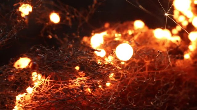 Close up, fire burns in steel wool