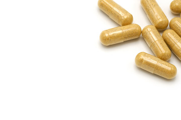Capsule herbal medicine Inside is a powdered brown powder. Used for eating on white background. copy space.