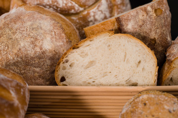 homemade sourdough bread in a wooden basket. Rustic style, selective focus