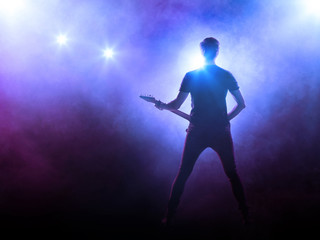 Fototapeta na wymiar Silhouette of guitar player on stage 