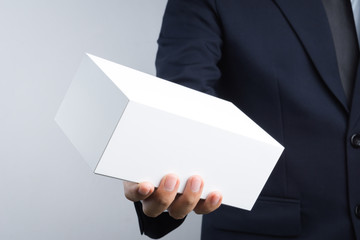 Business man hand holding blank white box give gift