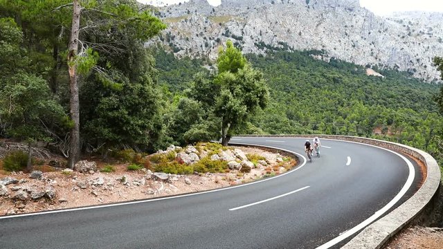 Cyclists riding up the Puig Major peak in Majorca, Spain