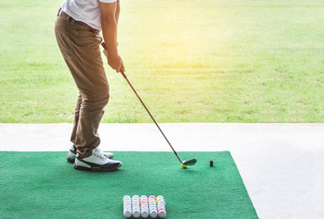   golfer during practice driving range in golf course yard signs