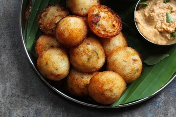 Kuzhi Paniyaram served with coconut chutney and sambar- South Indian breakfast with black  lentils and rice
