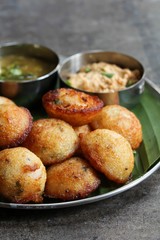 Kuzhi Paniyaram served with coconut chutney and sambar- South Indian breakfast with black  lentils and rice