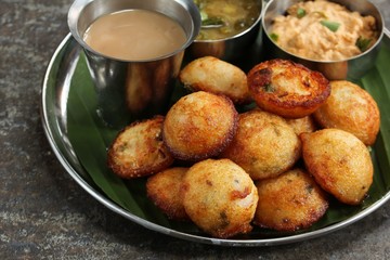 Kuzhi Paniyaram served with coconut chutney and sambar- South Indian breakfast with black  lentils and rice