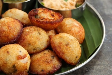 Kuzhi Paniyaram served with coconut chutney and sambar- South Indian breakfast with black  lentils and rice
