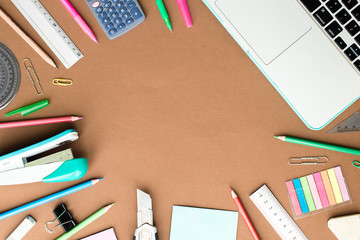 Set of stationery on brown table, top view. School Concept