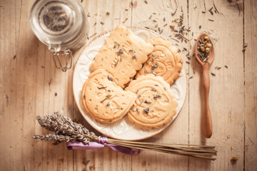 Lavender cookies with wooden spoon on the wooden surface
